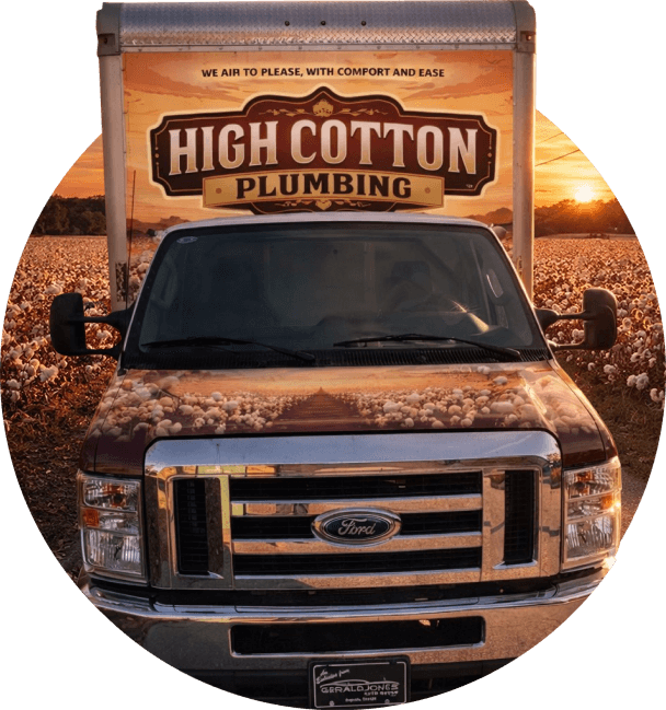 A plumbing truck with "High Cotton Plumbing" on the back and cotton field imagery on the hood is parked in a cotton field at sunset. Warm, serene atmosphere.